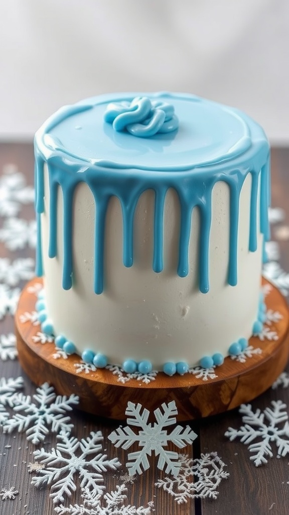 An icicle drip cake with blue frosting and snowflake decorations on a wooden stand.